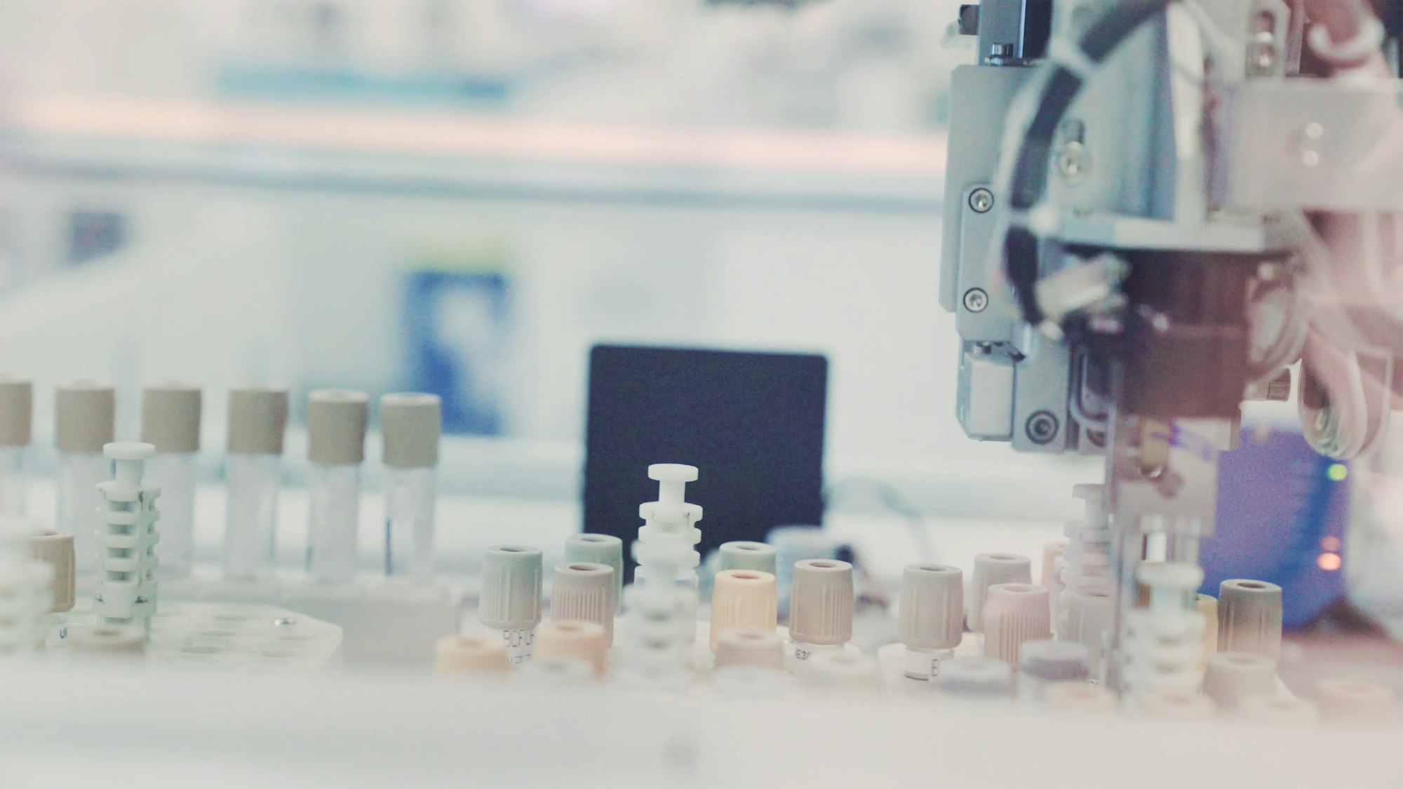photo-1599727277757-3f54e54ea618 Sample tubes move through an automated analysis line in a large diagnostic laboratory.
