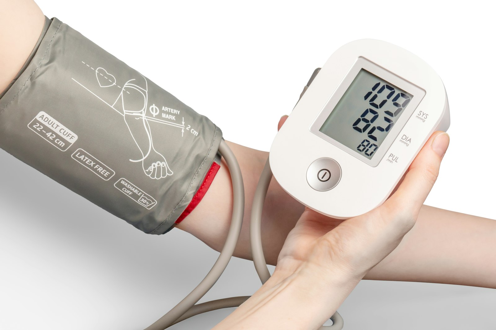 Digital blood pressure monitor A digital blood pressure monitor with a grey cuff fitted on a person's upper arm