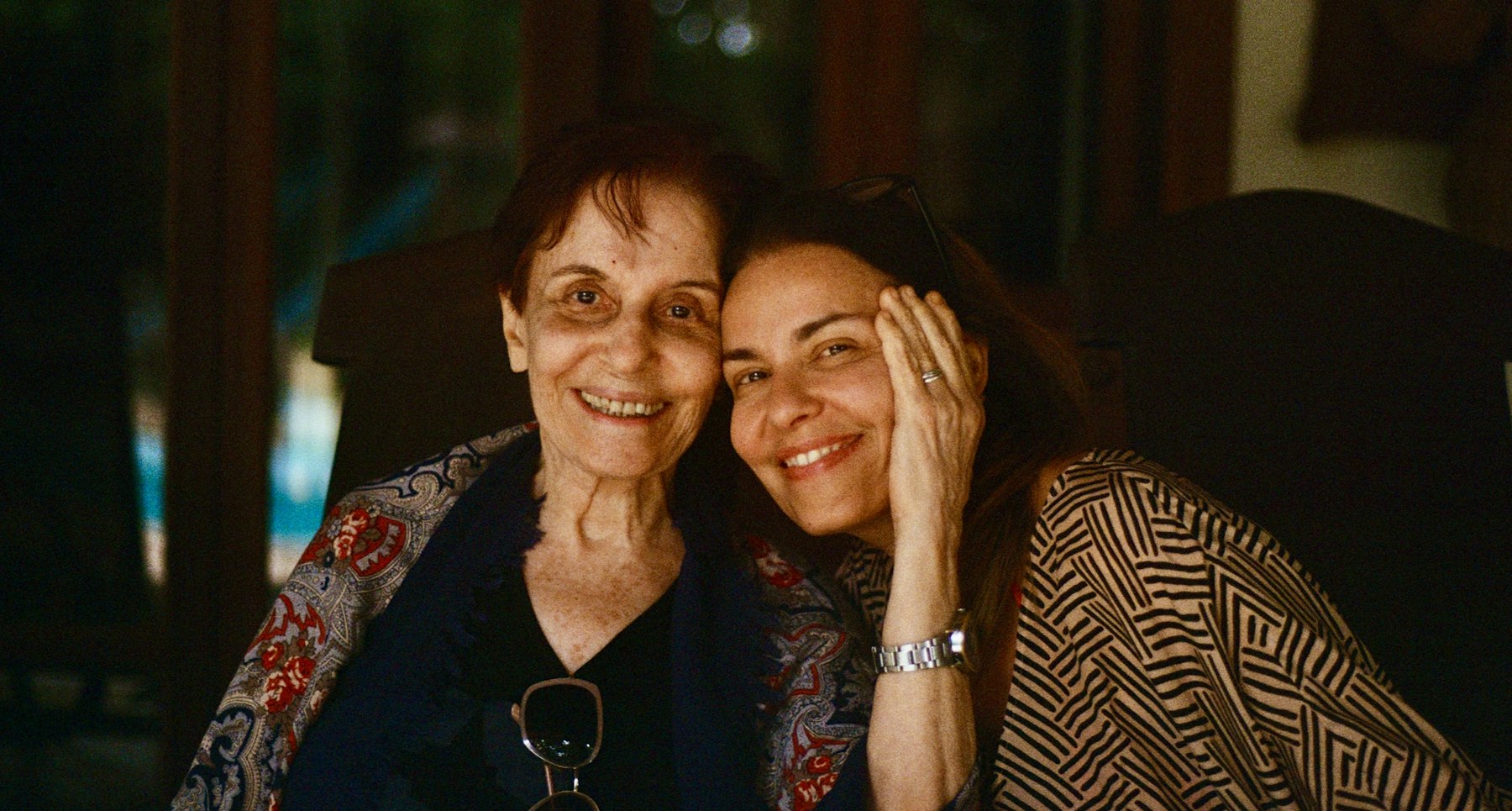 photo-1741651366517-cf81c7de3868 A mother and daughter embrace and smile.