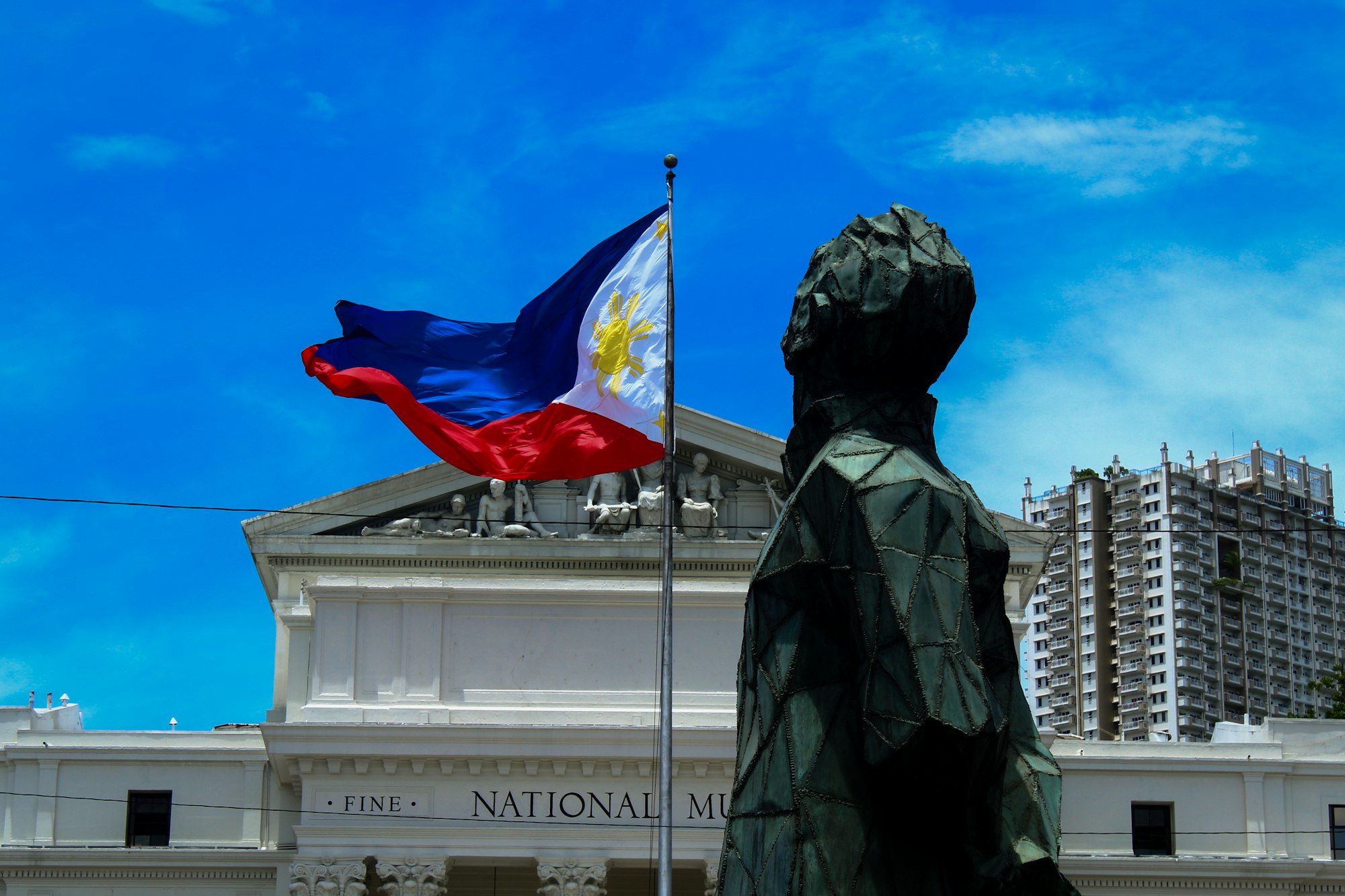 photo-1782555252604-0f546934dc3e The Philippine flag flying in front of the National Museum of Fine Arts in Manila.